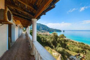 Blick durch ein beschädigtes Fenster des Gordios Ocean View Hotels auf die Bucht von Agios Gordios